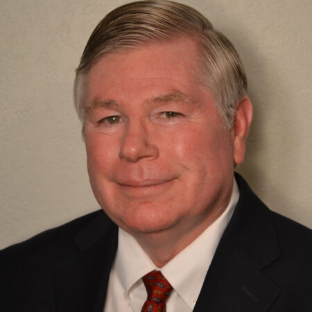 Portrait of a middle-aged man in a suit and tie.